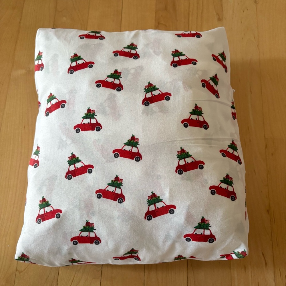 Festive Red Car Holiday twin fitted sheets in a zip case